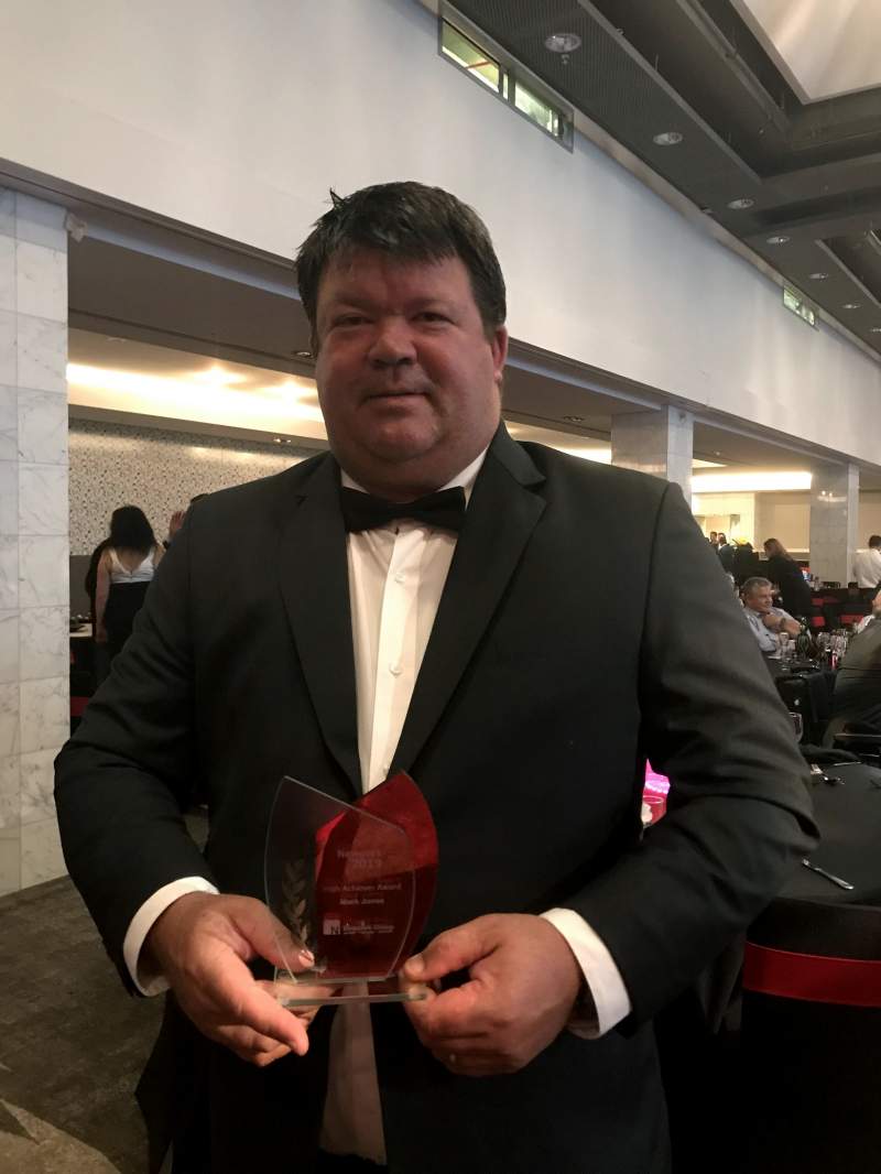 Mark holding award